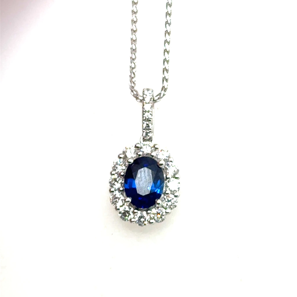 Lady's White 18 Karat Pendant With One = 1.39Ct Oval Sapphire And 18 = 0.65Tw Round Diamonds